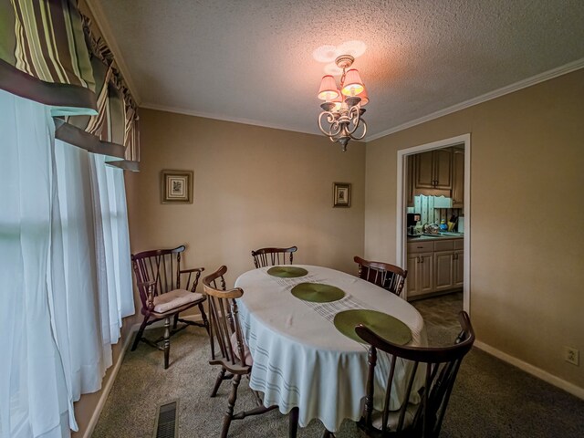 128 Airport Rd, Sylvester, GA 31791 - carpeted dining room with a chandelier, ornamental molding, a textured ceiling, baseboards, and a sink