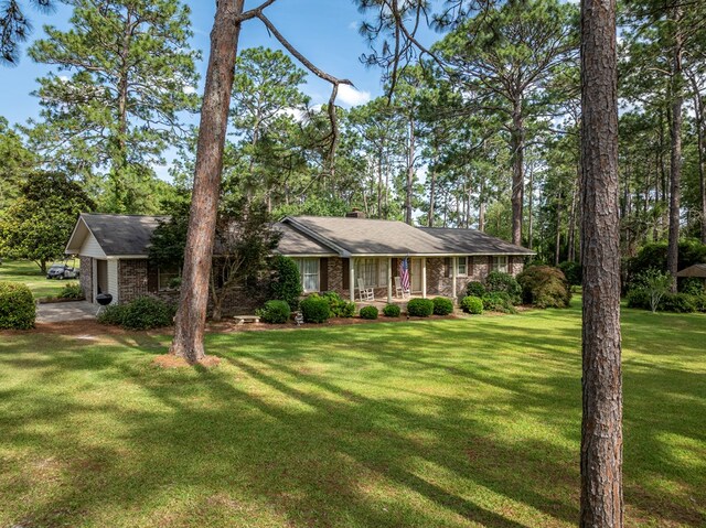 128 Airport Rd, Sylvester, GA 31791 - ranch-style home with a front yard, brick siding, a porch, and a chimney