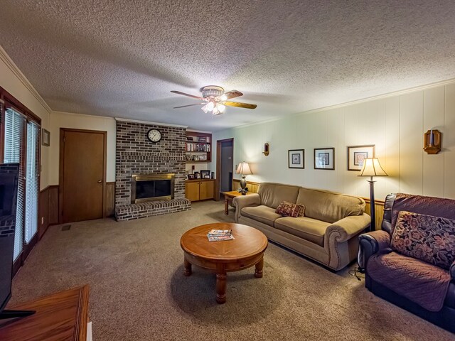 128 Airport Rd, Sylvester, GA 31791 - carpeted living area with a fireplace, a textured ceiling, ceiling fan, ornamental molding, and a decorative wall