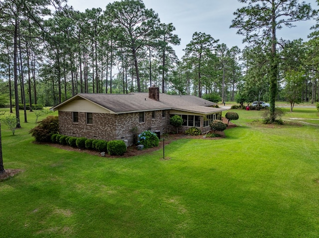128 Airport Rd, Sylvester, GA 31791 - rear view of property featuring a chimney, a lawn, brick siding, and view of scattered trees