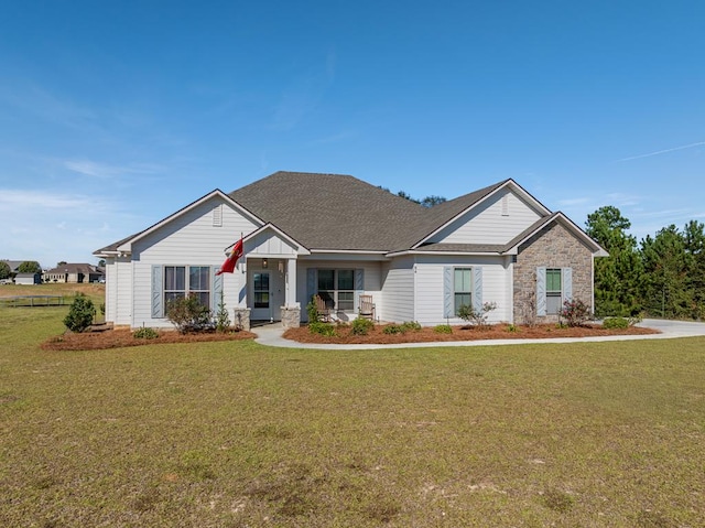 56 Willow Creek Dr, Tifton, GA 31793 - view of front of property featuring a front yard, stone siding, and roof with shingles