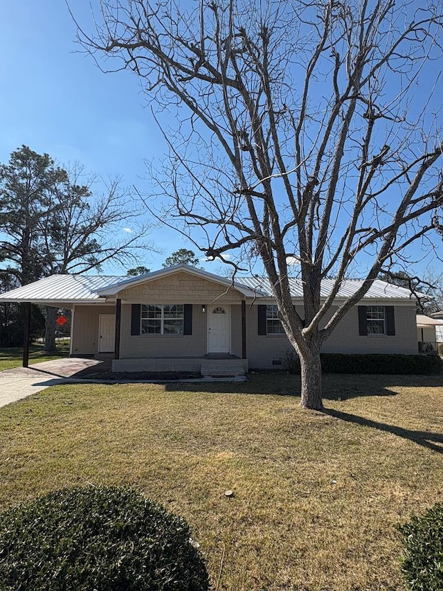 single story home with driveway, a carport, and a front yard
