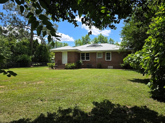 105 Gaff Ave, Fitzgerald, GA 31750 - exterior space featuring a lawn, central air condition unit, brick siding, and fence