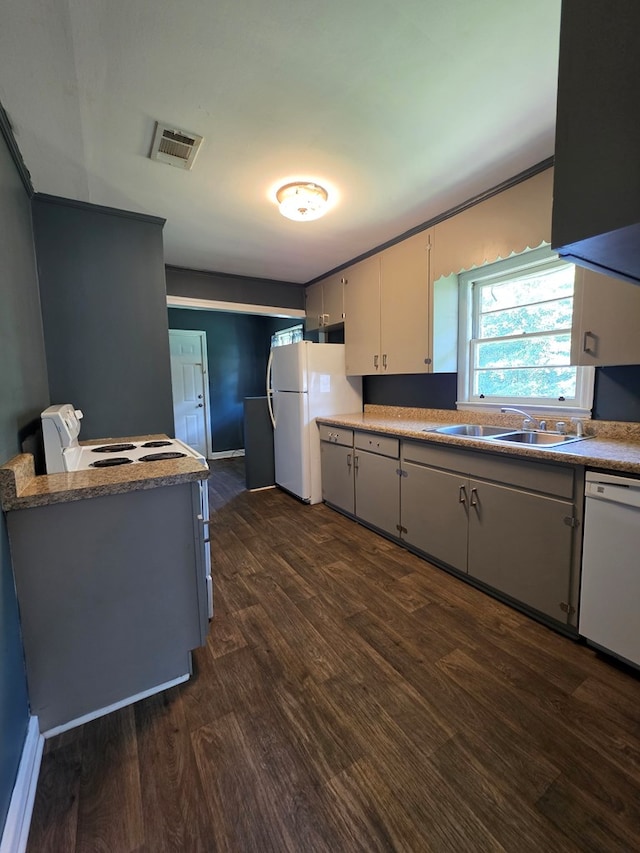 105 Gaff Ave, Fitzgerald, GA 31750 - kitchen featuring a sink, dark wood-style flooring, white appliances, and visible vents