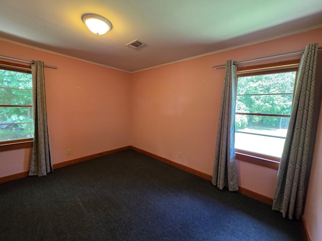 105 Gaff Ave, Fitzgerald, GA 31750 - unfurnished room with dark colored carpet, baseboards, visible vents, and ornamental molding