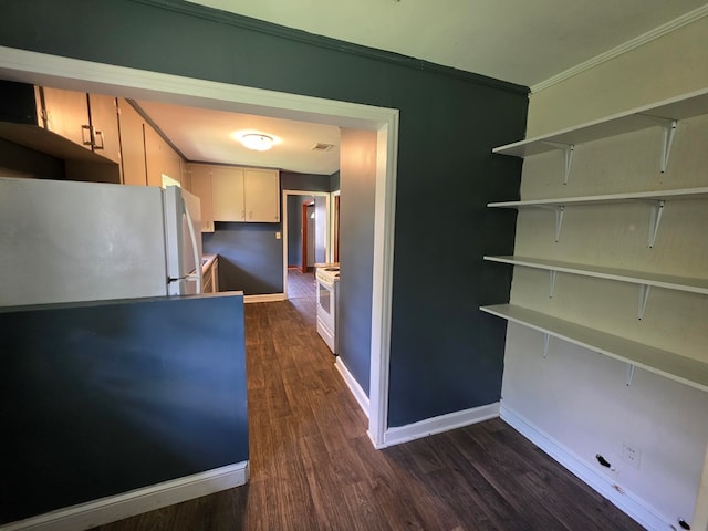 105 Gaff Ave, Fitzgerald, GA 31750 - kitchen featuring freestanding refrigerator, baseboards, visible vents, crown molding, and dark wood-style floors