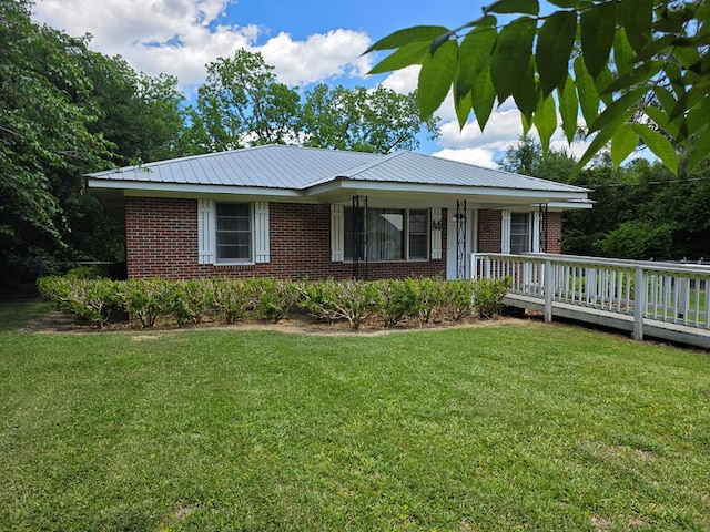 105 Gaff Ave, Fitzgerald, GA 31750 - single story home with metal roof, brick siding, a front lawn, and a deck