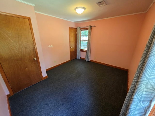 105 Gaff Ave, Fitzgerald, GA 31750 - unfurnished room with crown molding, baseboards, visible vents, and dark carpet