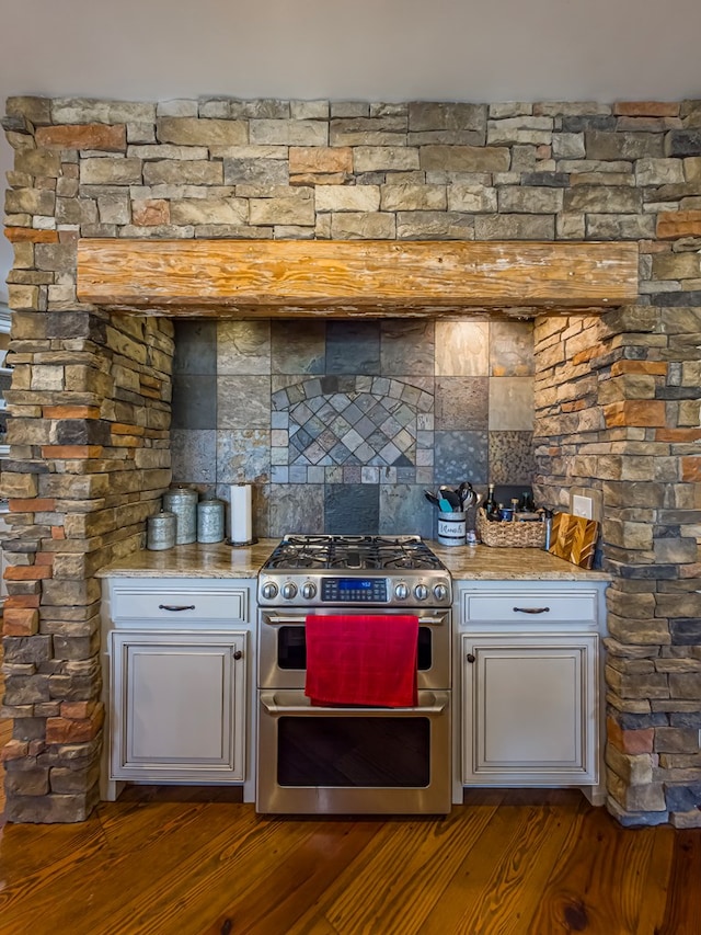 248 Gun Lake Loop, Tifton, GA 31794 - kitchen featuring range with two ovens, wood finished floors, tasteful backsplash, and light stone countertops