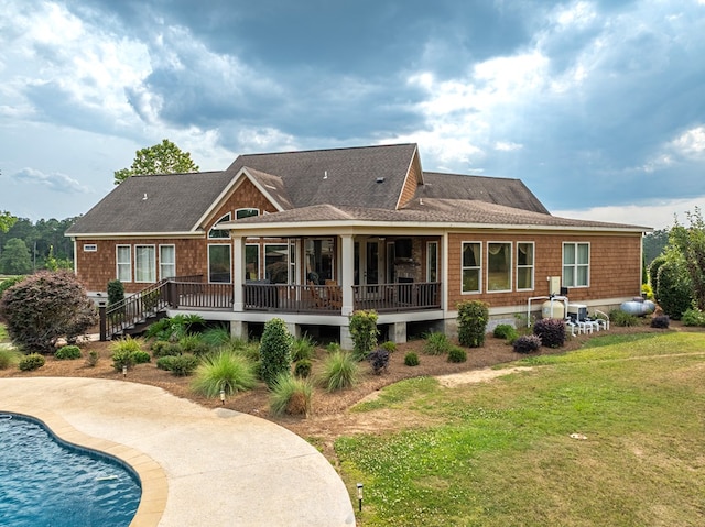 248 Gun Lake Loop, Tifton, GA 31794 - rear view of house featuring a yard, an outdoor pool, a deck, a sunroom, and roof with shingles