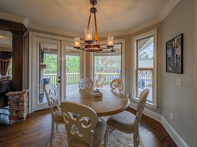 248 Gun Lake Loop, Tifton, GA 31794 - dining space featuring a chandelier, plenty of natural light, dark wood finished floors, and crown molding