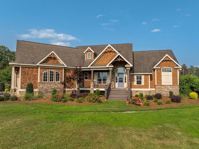 248 Gun Lake Loop, Tifton, GA 31794 - craftsman-style home featuring stone siding, a front lawn, a porch, and a shingled roof