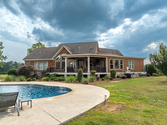 248 Gun Lake Loop, Tifton, GA 31794 - rear view of house featuring a lawn, an outdoor pool, a wooden deck, a patio area, and a sunroom