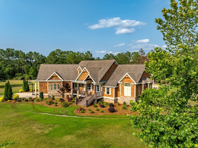 248 Gun Lake Loop, Tifton, GA 31794 - craftsman-style house featuring a front yard, stone siding, and view of wooded area