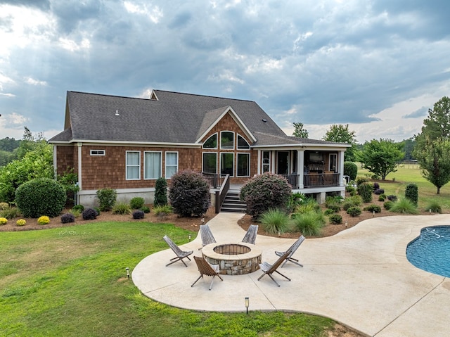 248 Gun Lake Loop, Tifton, GA 31794 - rear view of property featuring a fire pit, a lawn, a patio, and roof with shingles