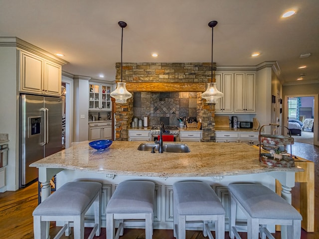 248 Gun Lake Loop, Tifton, GA 31794 - kitchen with stainless steel fridge with ice dispenser, light stone counters, pendant lighting, crown molding, and glass insert cabinets