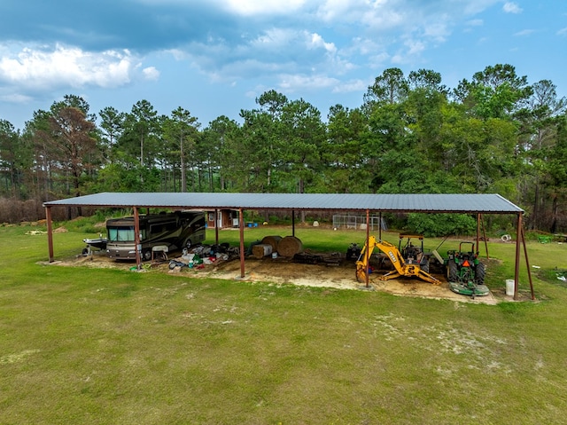 248 Gun Lake Loop, Tifton, GA 31794 - view of green lawn with a detached carport and view of wooded area