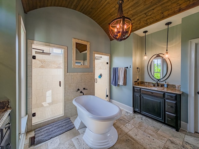 248 Gun Lake Loop, Tifton, GA 31794 - full bathroom featuring vanity, stone tile floors, vaulted ceiling, a shower stall, and tile walls