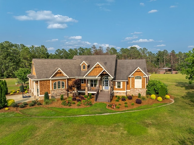 248 Gun Lake Loop, Tifton, GA 31794 - craftsman house featuring stone siding, a porch, a front yard, concrete driveway, and roof with shingles