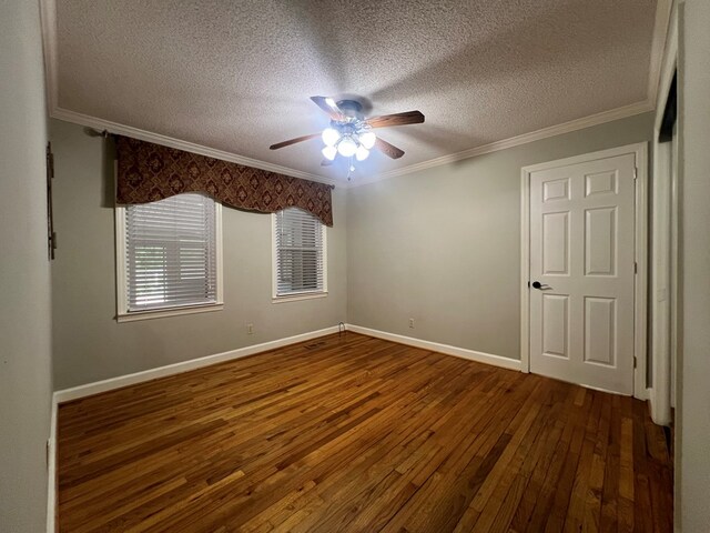 unfurnished bedroom with crown molding, hardwood / wood-style floors, baseboards, and a textured ceiling