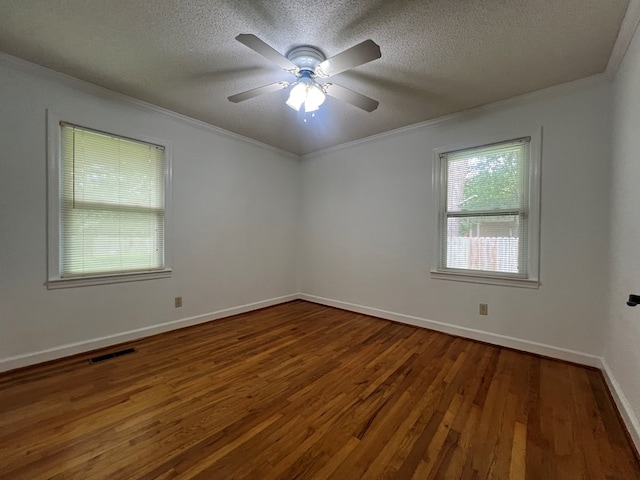 unfurnished room featuring ornamental molding, baseboards, wood finished floors, and a textured ceiling