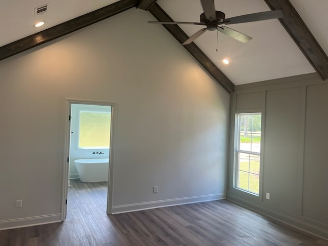spare room with visible vents, dark wood-type flooring, beam ceiling, baseboards, and ceiling fan