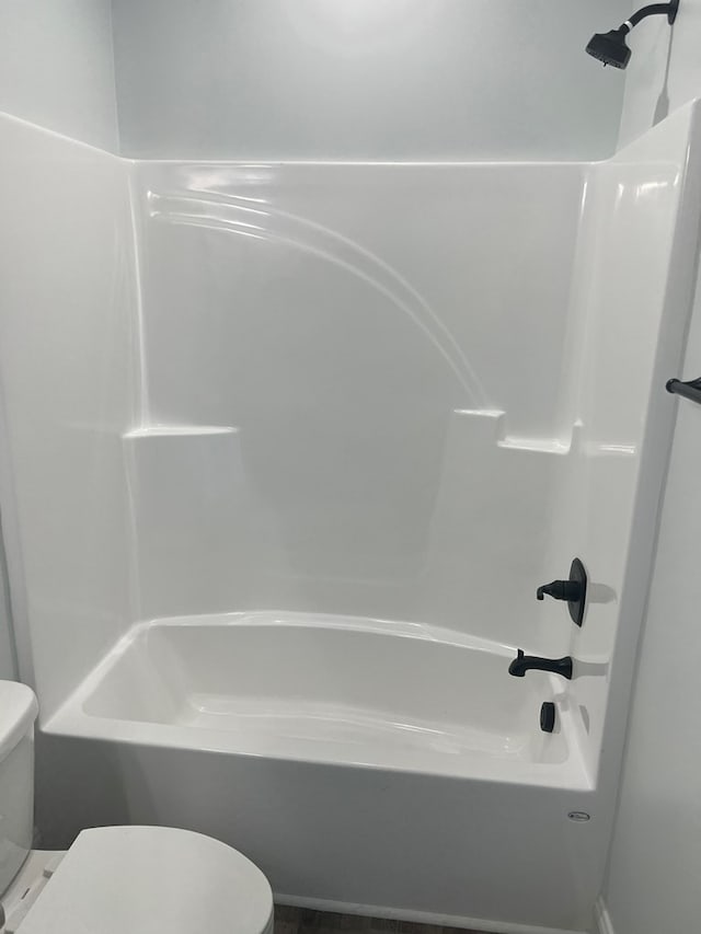 bathroom with shower / bathtub combination and toilet