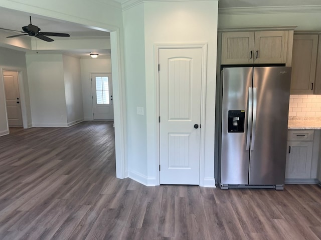 kitchen featuring crown molding, stainless steel fridge, backsplash, baseboards, and dark wood-style floors