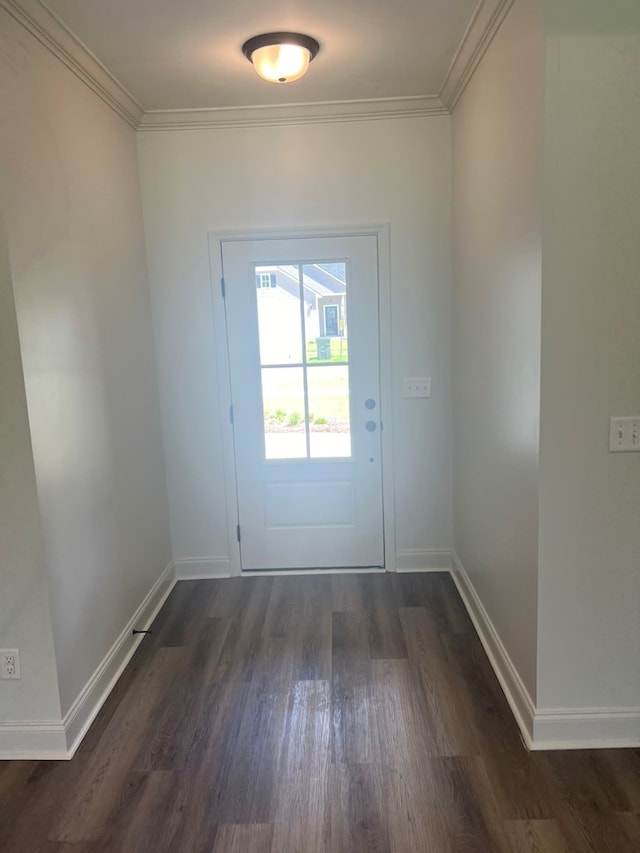 doorway to outside featuring dark wood finished floors, baseboards, and ornamental molding