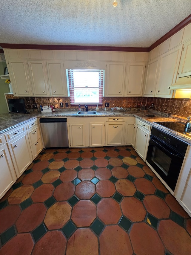 kitchen with black appliances, a sink, tasteful backsplash, a textured ceiling, and cream cabinets