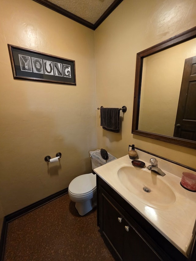 half bath featuring ornamental molding, vanity, toilet, and baseboards