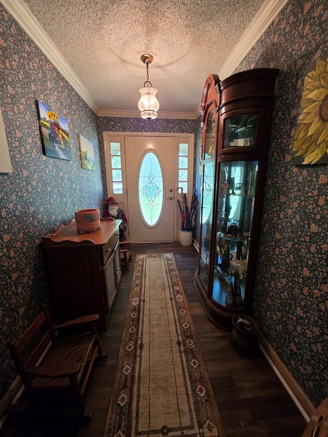 entryway with dark wood-type flooring, wallpapered walls, crown molding, and a textured ceiling