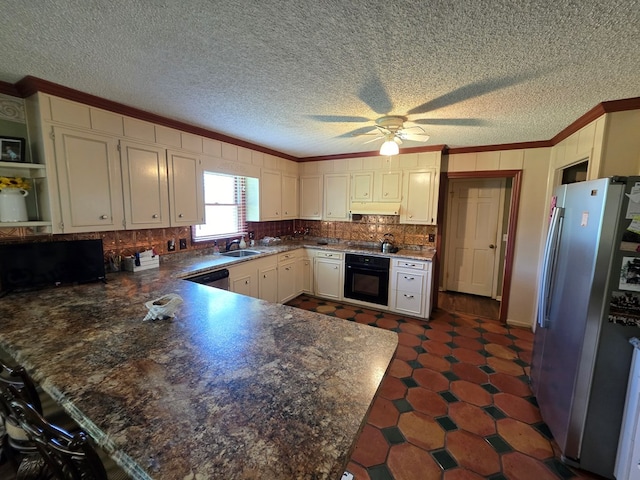 kitchen with black appliances, crown molding, a peninsula, a sink, and under cabinet range hood