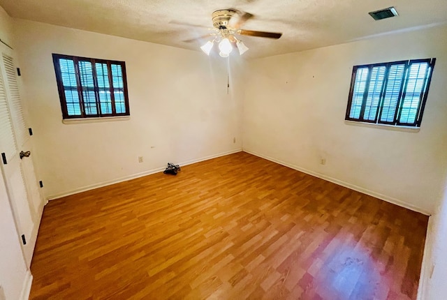 111 Van Deman Ct, Fitzgerald, GA 31750 - unfurnished room with wood finished floors, healthy amount of natural light, ceiling fan, and baseboards
