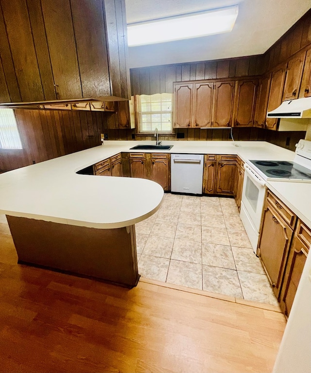 111 Van Deman Ct, Fitzgerald, GA 31750 - kitchen with stainless steel dishwasher, white electric range, range hood, a sink, and a peninsula