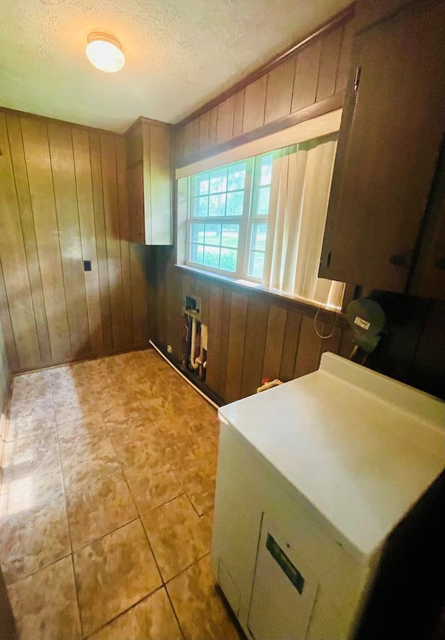 111 Van Deman Ct, Fitzgerald, GA 31750 - washroom featuring wood walls, a textured ceiling, hookup for a washing machine, and cabinet space