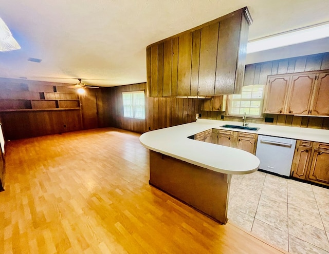 111 Van Deman Ct, Fitzgerald, GA 31750 - kitchen with dishwashing machine, a sink, light countertops, a peninsula, and a ceiling fan