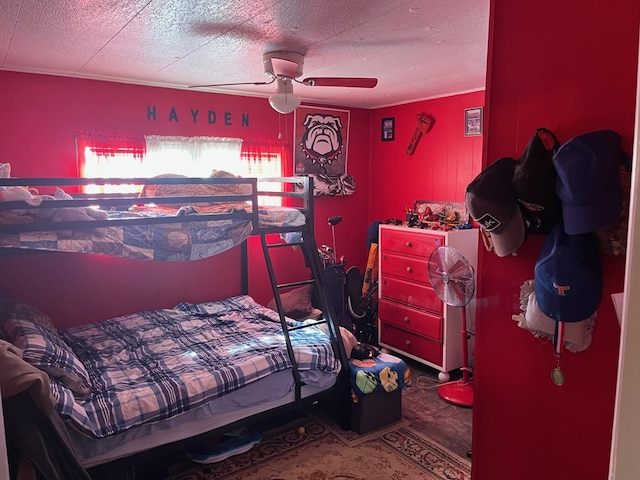 bedroom with a ceiling fan and a textured ceiling