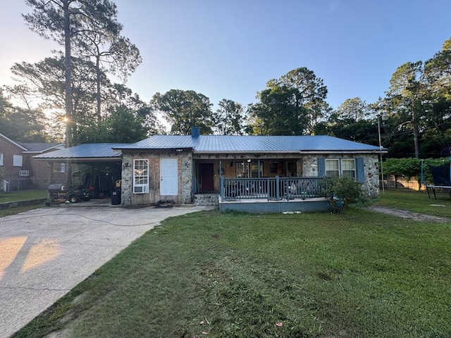 1003 Davis Ave, Tifton, GA 31794 - ranch-style house featuring stone siding, a porch, a trampoline, and a chimney