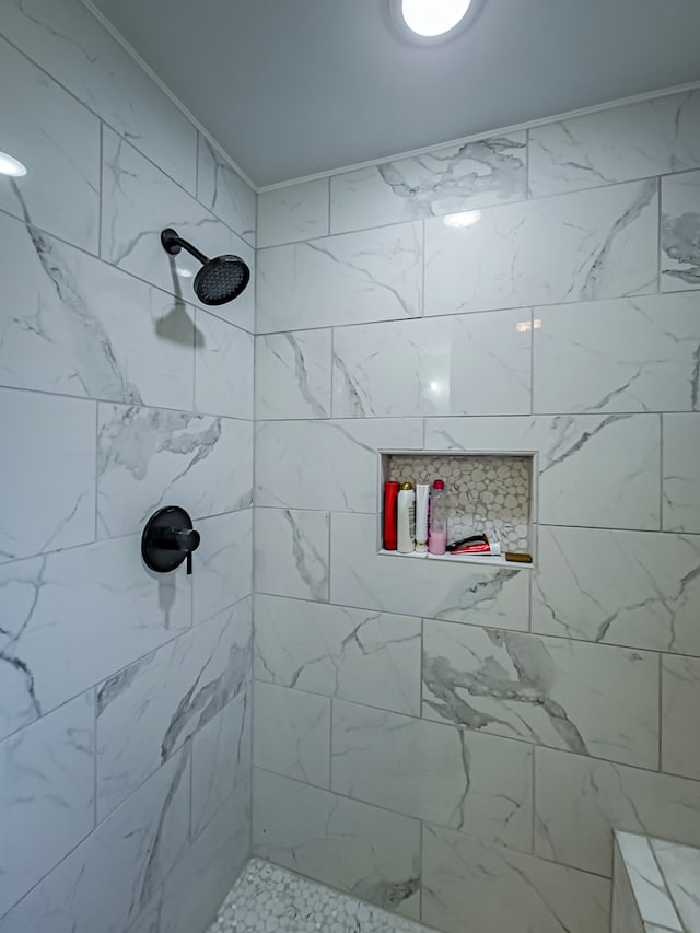 bathroom with tiled shower