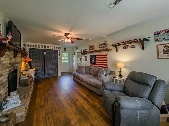 127 Carol Cir, Fitzgerald, GA 31750 - living area with dark wood finished floors, ceiling fan, and a brick fireplace