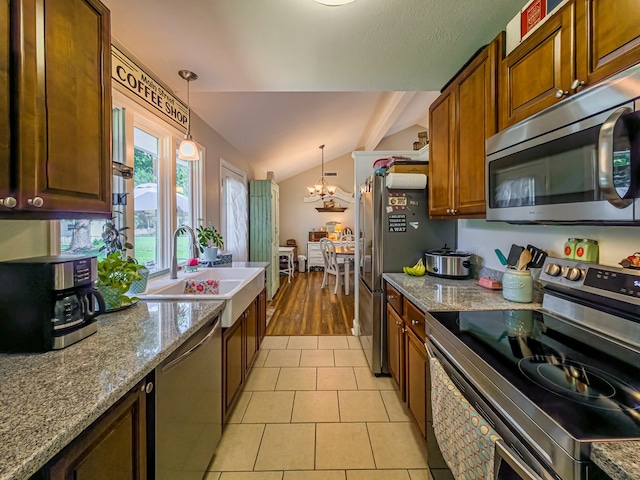 127 Carol Cir, Fitzgerald, GA 31750 - kitchen with stainless steel appliances, a chandelier, lofted ceiling, pendant lighting, and light tile patterned floors