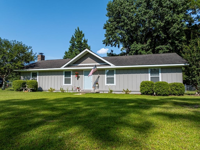 127 Carol Cir, Fitzgerald, GA 31750 - ranch-style house with board and batten siding, a front lawn, a chimney, and roof with shingles