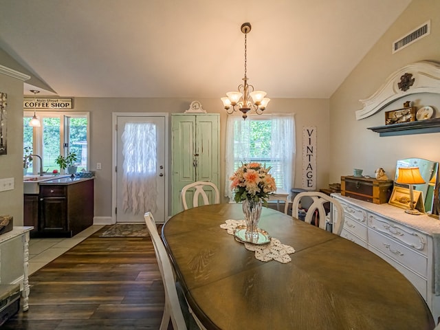 127 Carol Cir, Fitzgerald, GA 31750 - dining space with vaulted ceiling, wood finished floors, and a chandelier