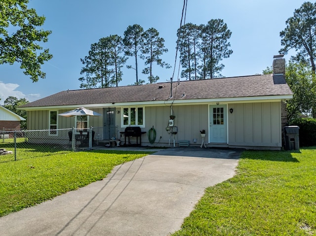 127 Carol Cir, Fitzgerald, GA 31750 - view of front facade with board and batten siding, a chimney, driveway, and a shingled roof