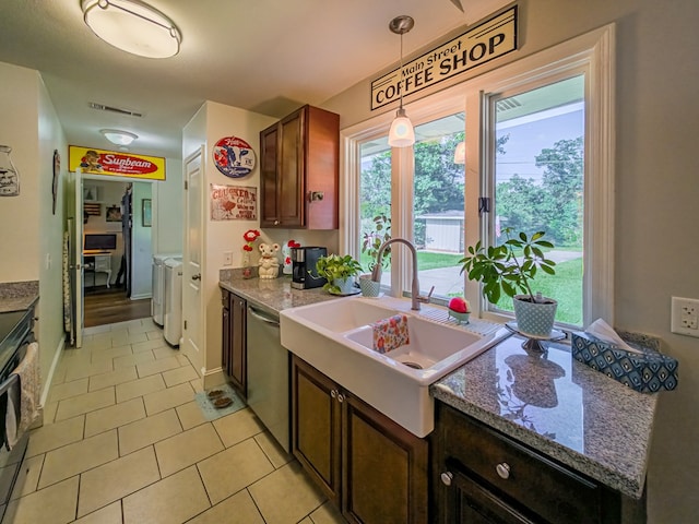 127 Carol Cir, Fitzgerald, GA 31750 - kitchen featuring washer and clothes dryer, stainless steel dishwasher, light tile patterned floors, decorative light fixtures, and range with electric cooktop