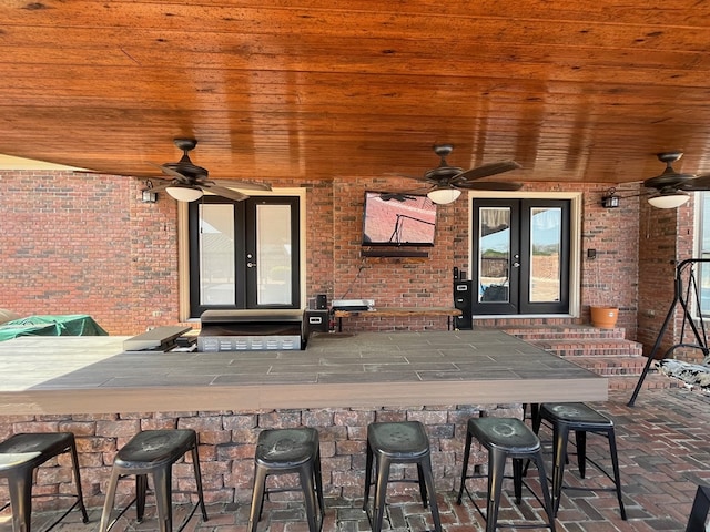 view of patio / terrace with entry steps, french doors, and a ceiling fan