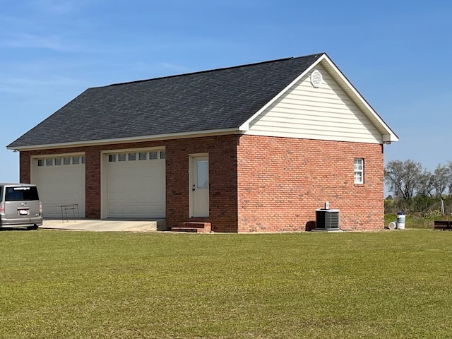 view of property exterior with roof with shingles, a lawn, central AC unit, and brick siding