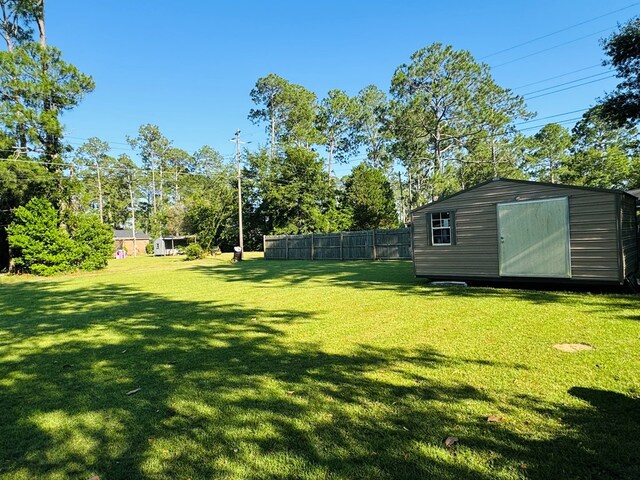 106 Pendley St, Sylvester, GA 31791 - view of yard featuring a shed, fence, and an outbuilding