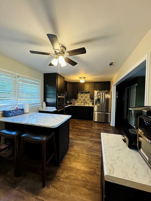 106 Pendley St, Sylvester, GA 31791 - kitchen with tasteful backsplash, dark wood-style flooring, visible vents, ceiling fan, and stainless steel appliances